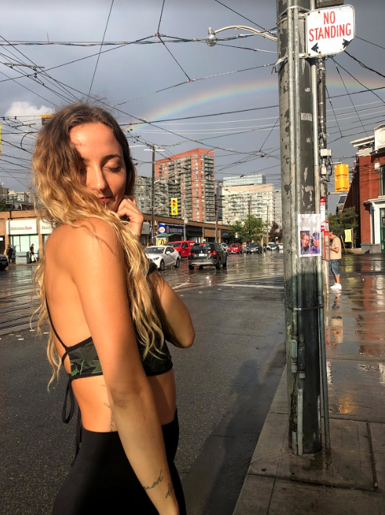 Anja Todorovic standing on the street in Toronto near her yoga studio