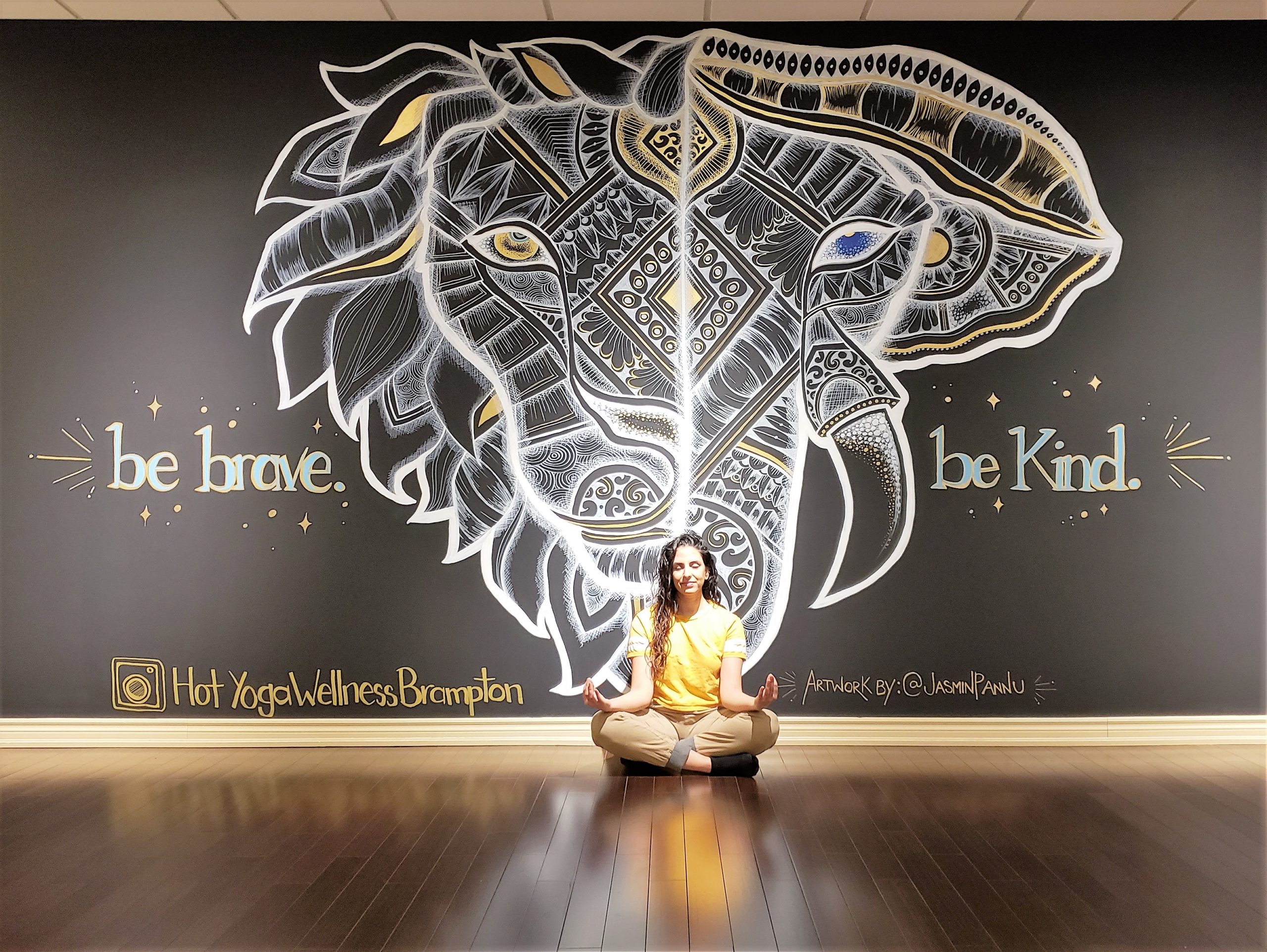 Jasmin Pannu and the business wall art she created for a yoga studio