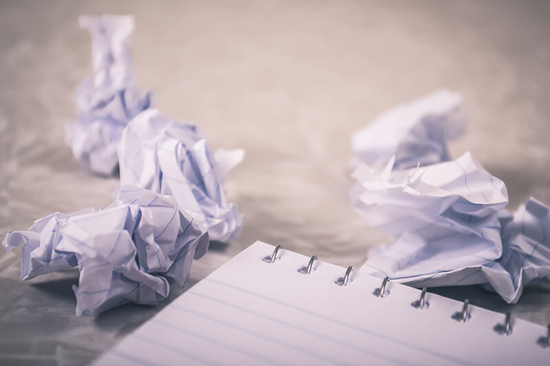 A notebook and crumpled papers used for the brainstorm process