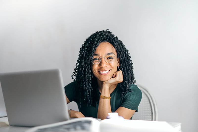 Young female business owner building her company online on a laptop