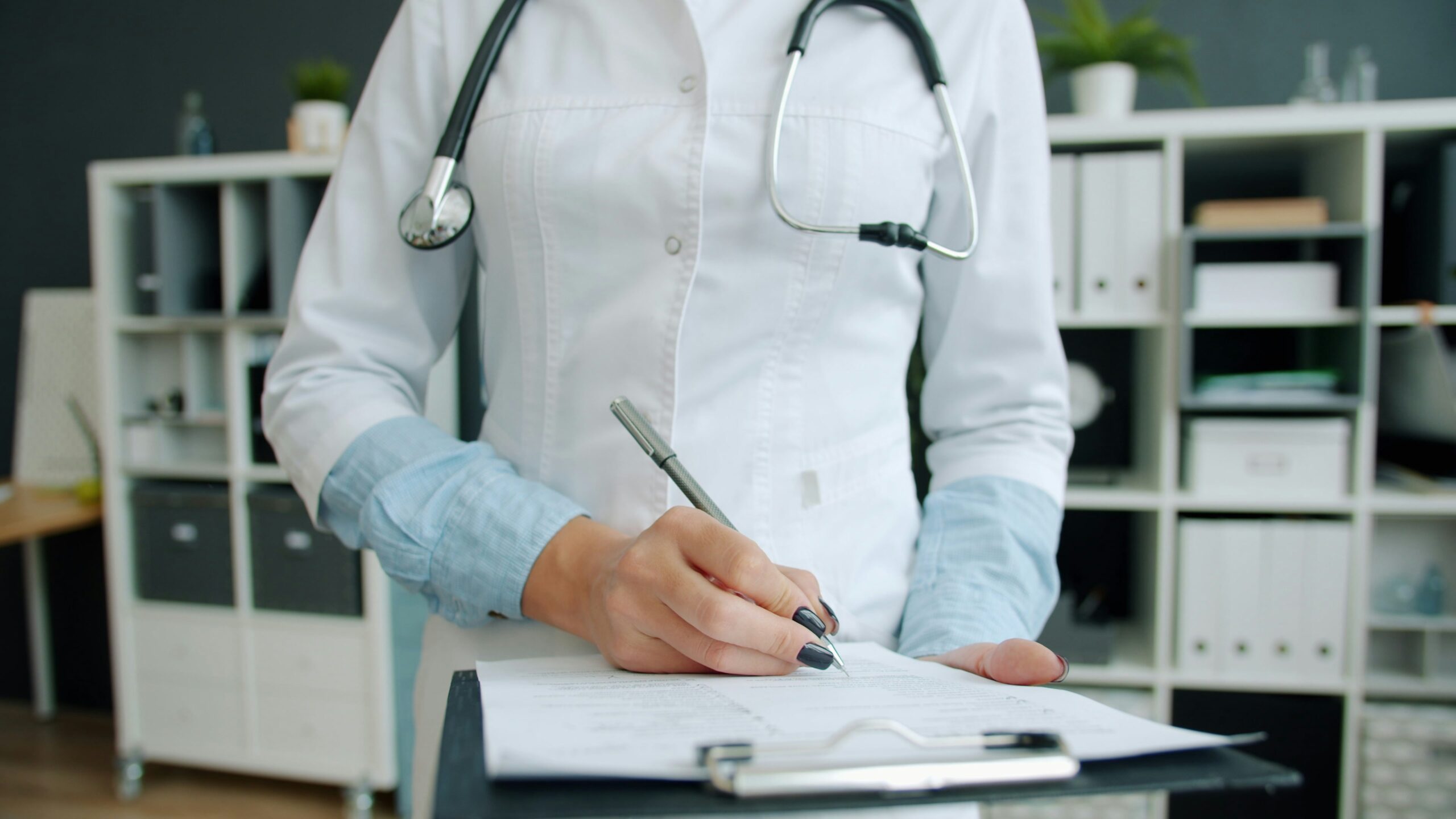 A professional healthcare administrator reviewing a Request for Proposal (RFP) document on a tablet in a hospital setting.